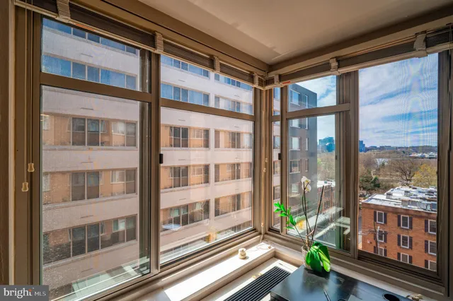 a living room with furniture and a lamp
