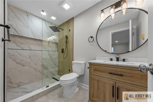 a bathroom with a sink mirror toilet and shower