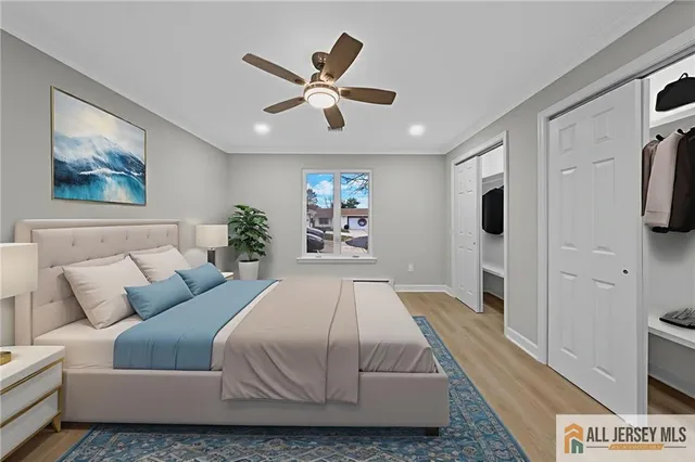 a spacious bedroom with a bed and a flat screen tv