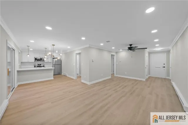 a view of a kitchen with a sink and a refrigerator