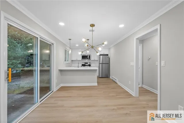 a view of kitchen with granite countertop cabinets a refrigerator and a fireplace