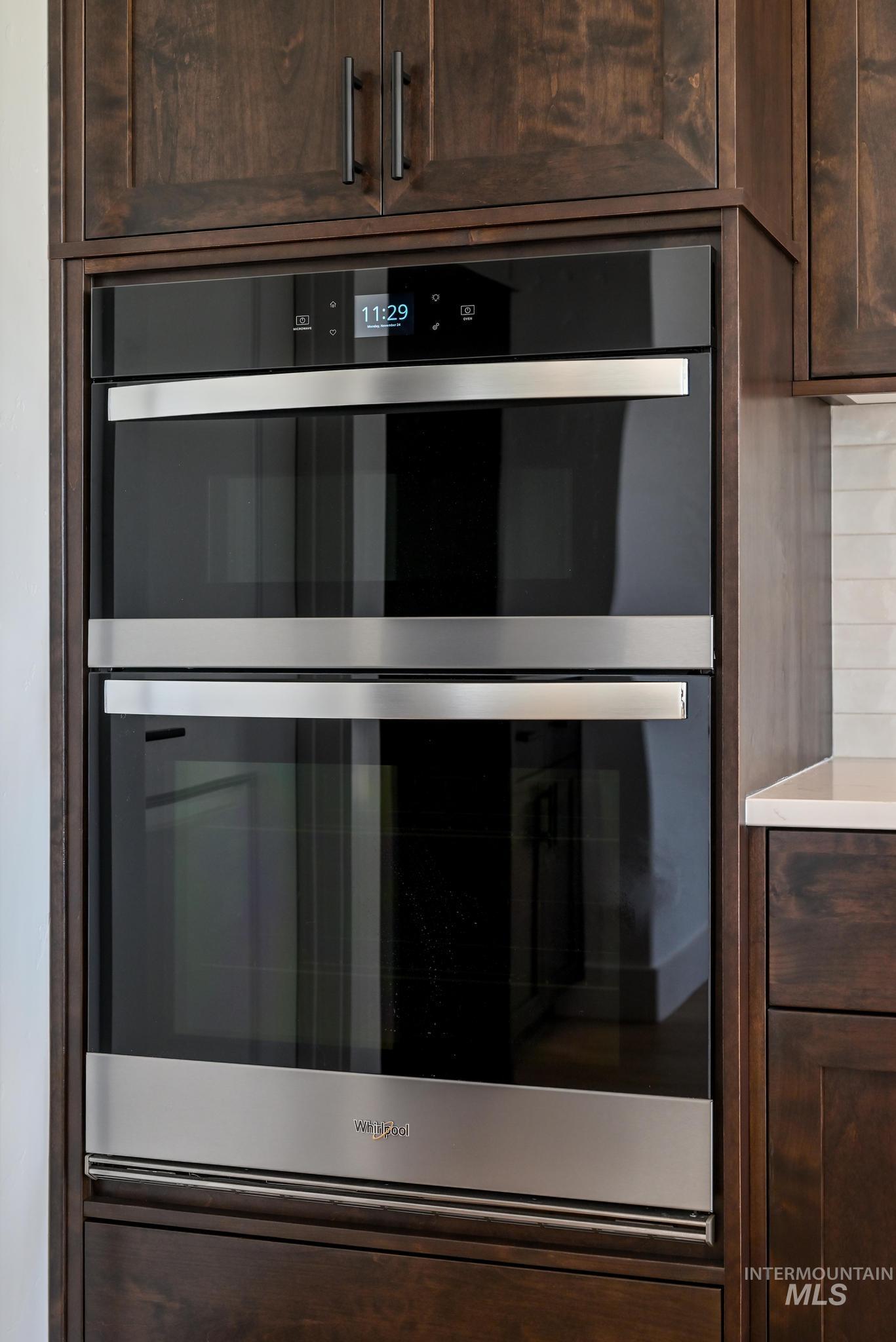9085 West Patmore Court Star, ID 83669 - Photo 12 of 40 Detailed view of dark brown cabinetry and stainless steel double oven