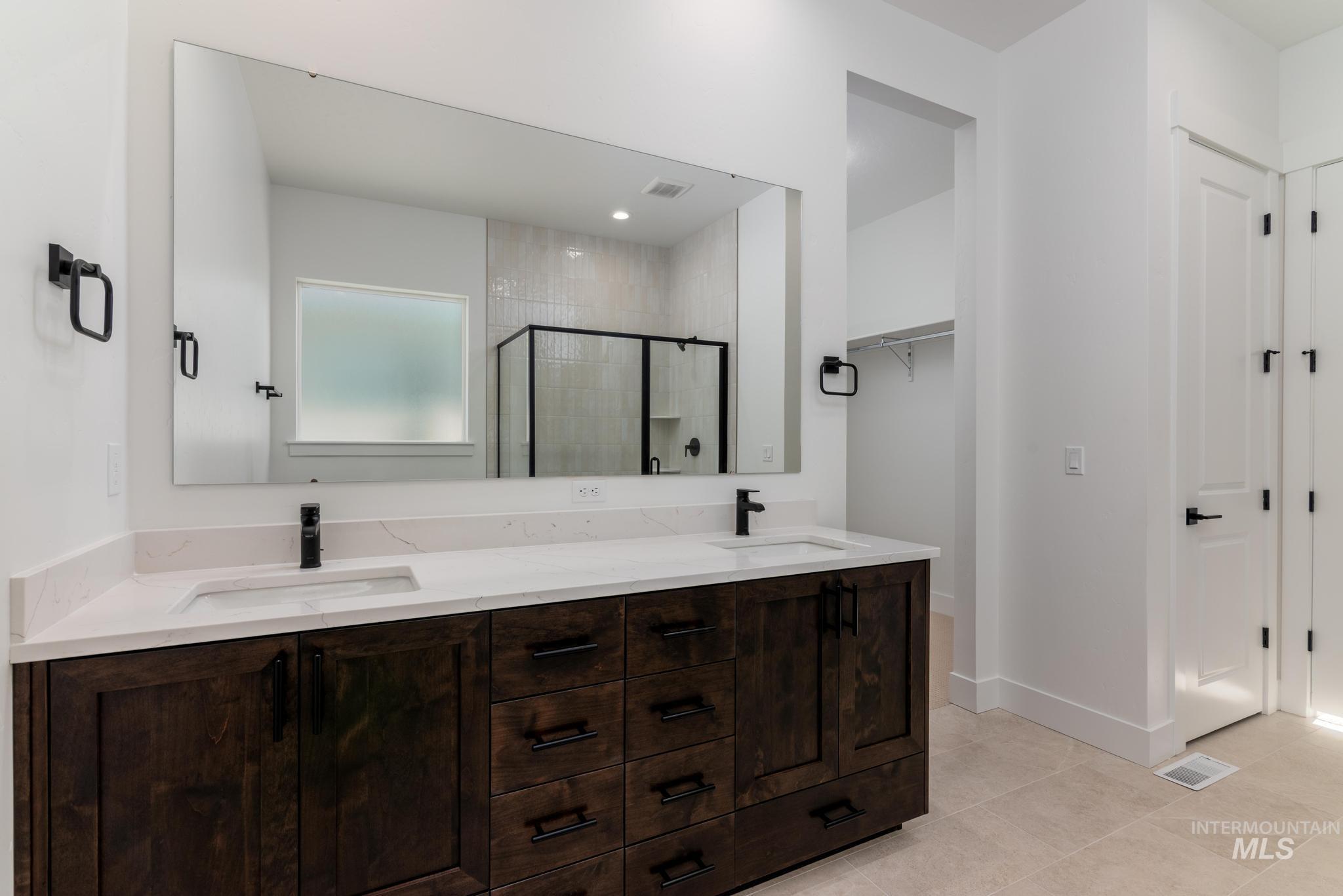 9085 West Patmore Court Star, ID 83669 - Photo 21 of 40 Full bath with double vanity, a stall shower, and light tile patterned floors