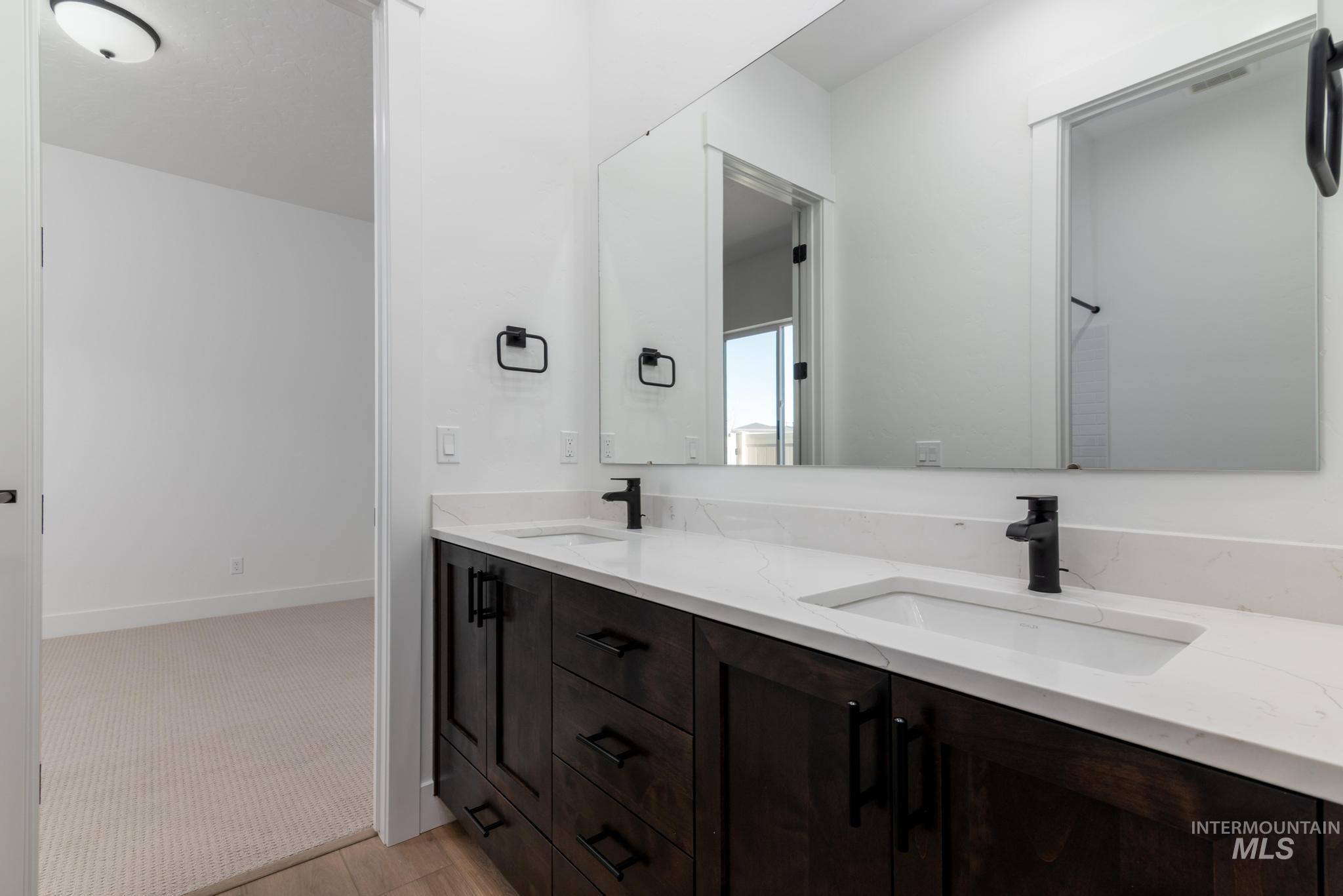 9085 West Patmore Court Star, ID 83669 - Photo 23 of 40 Full bathroom featuring double vanity and light colored carpet