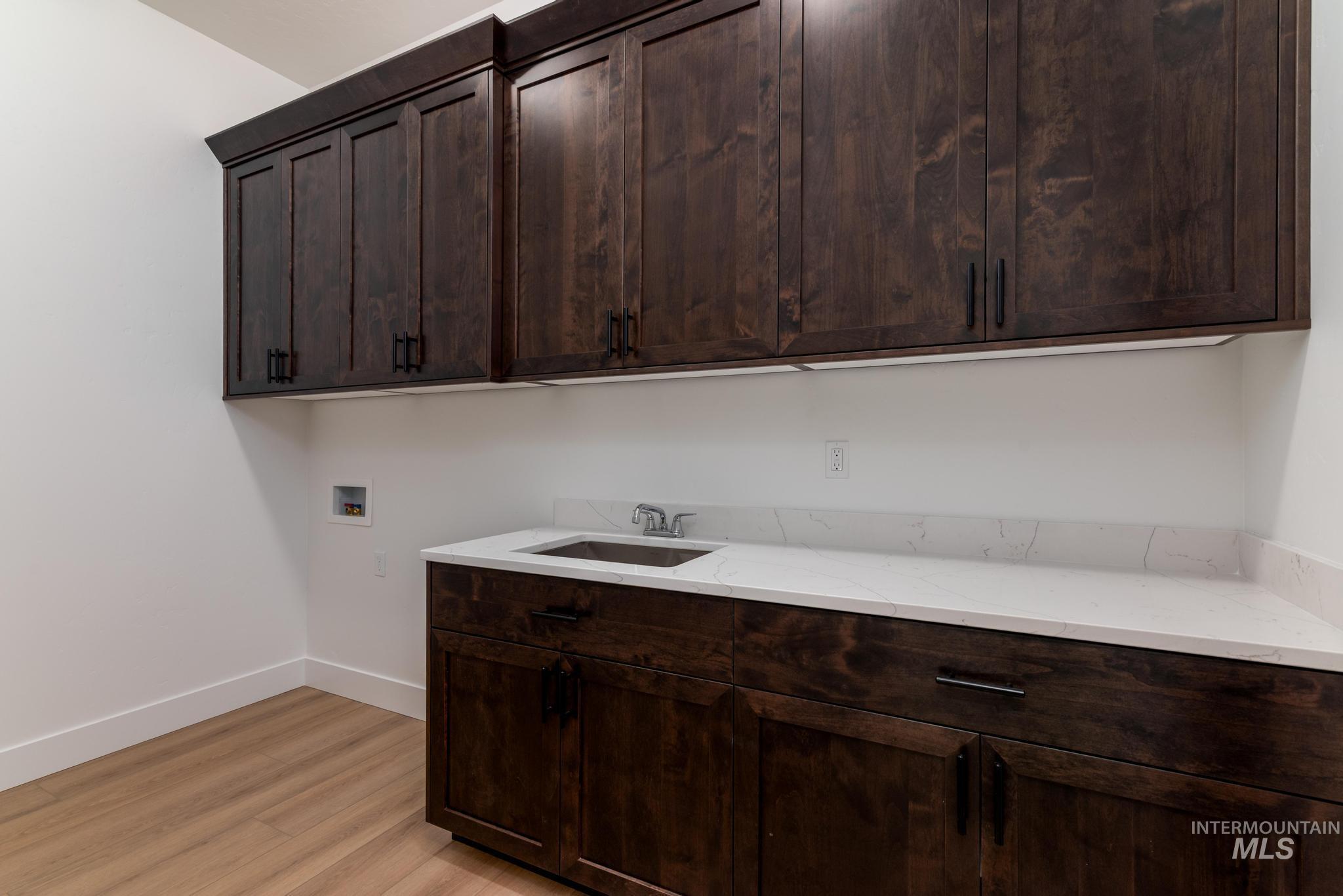 9085 West Patmore Court Star, ID 83669 - Photo 27 of 40 Washroom featuring light wood-type flooring, washer hookup, and cabinet space