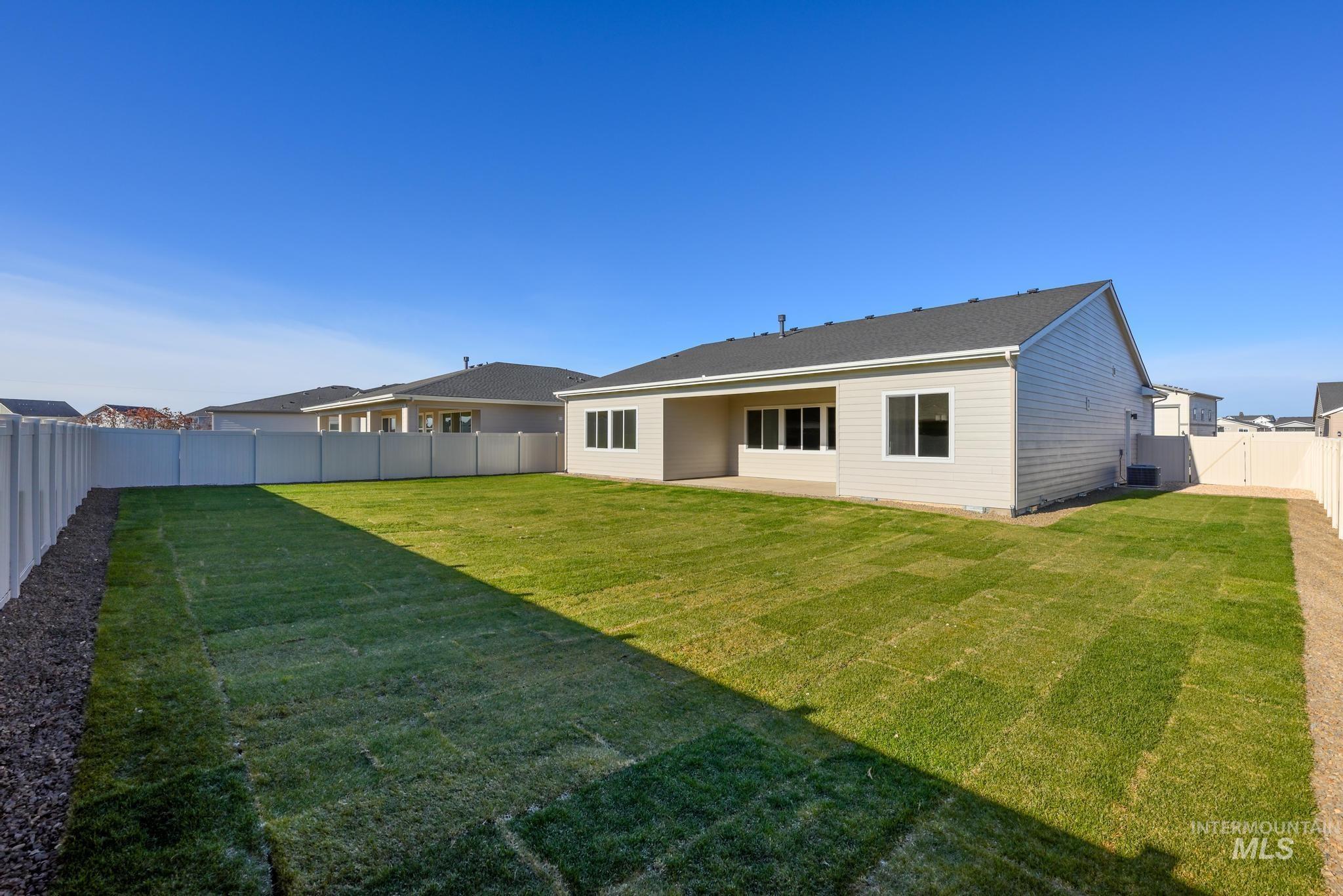 9085 West Patmore Court Star, ID 83669 - Photo 29 of 40 Rear view of house featuring a fenced backyard and a patio area
