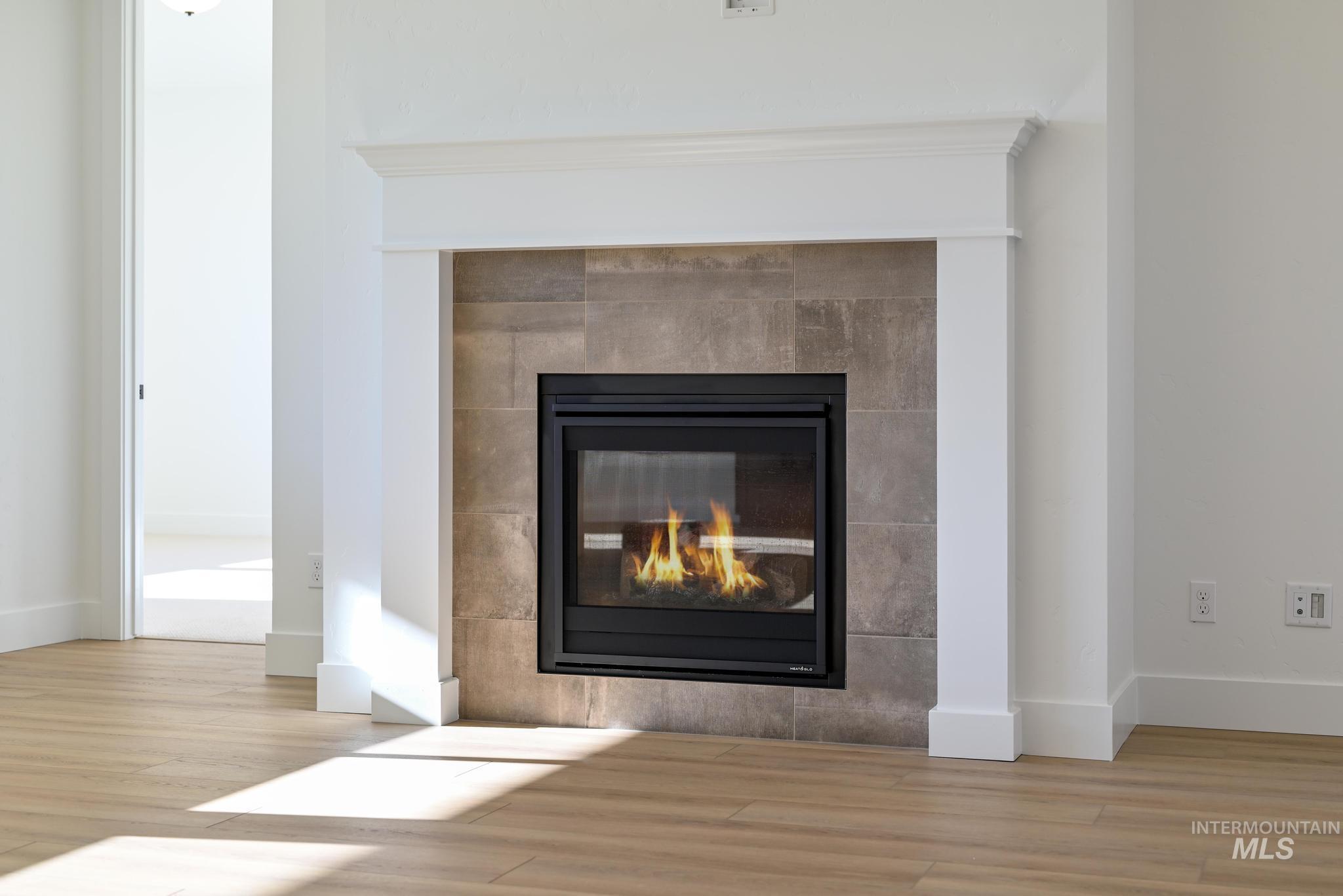 9085 West Patmore Court Star, ID 83669 - Photo 6 of 40 Detailed view of wood finished floors and a fireplace