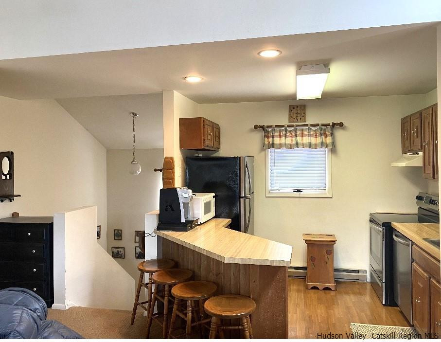 72 Hunter Ridge, Unit L1 Hunter, NY 12442 - Photo 11 of 23 a living room with furniture and a fireplace