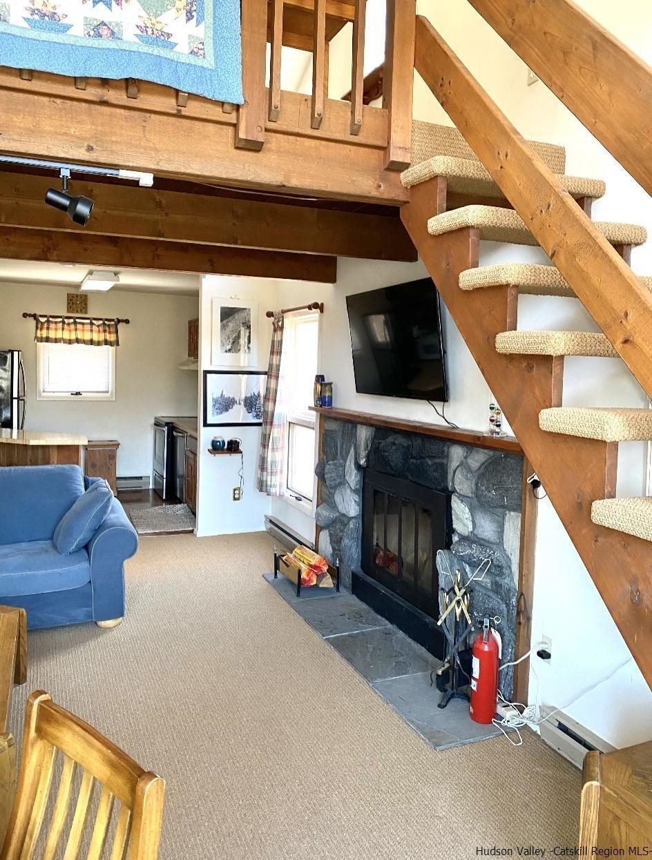 72 Hunter Ridge, Unit L1 Hunter, NY 12442 - Photo 13 of 23 a living room with furniture and a fireplace