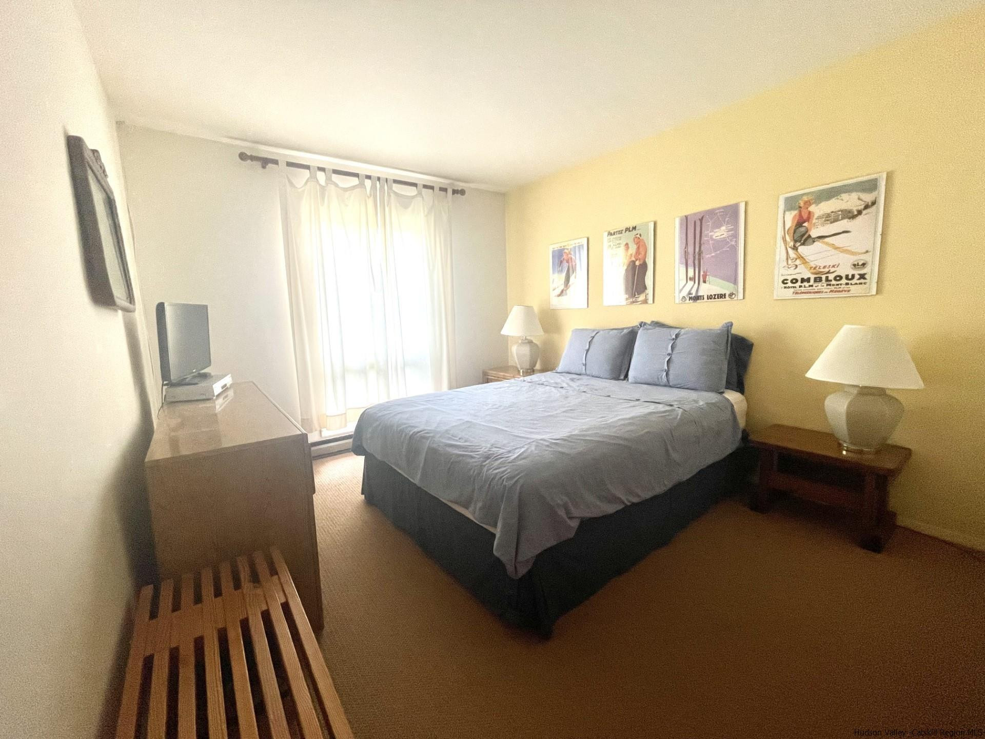 72 Hunter Ridge, Unit L1 Hunter, NY 12442 - Photo 15 of 23 a bedroom with a bed and wooden floor