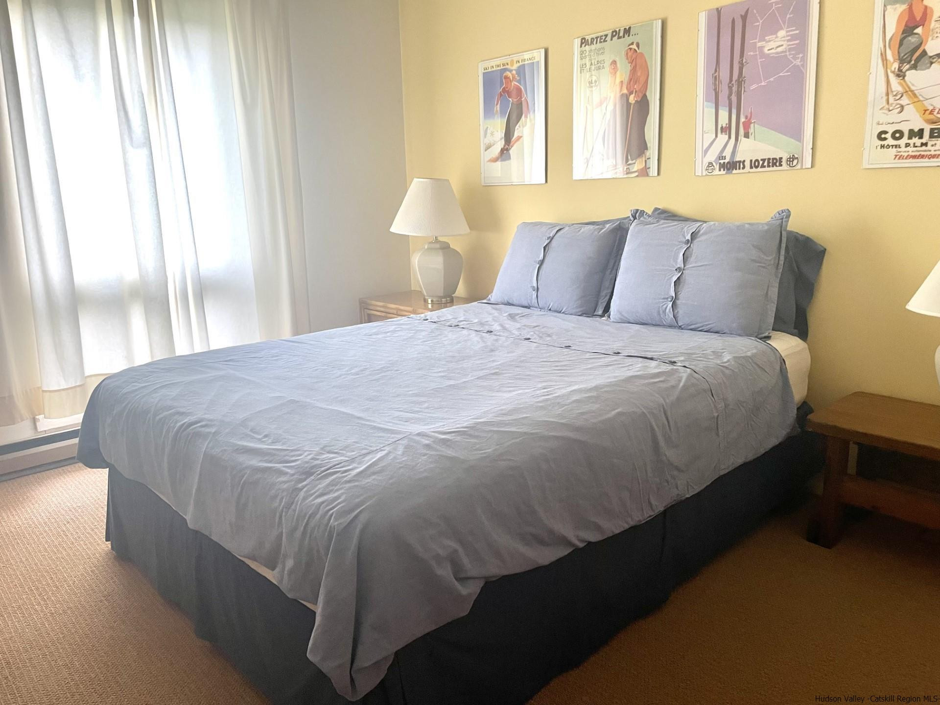 72 Hunter Ridge, Unit L1 Hunter, NY 12442 - Photo 16 of 23 a bedroom with a bed and window