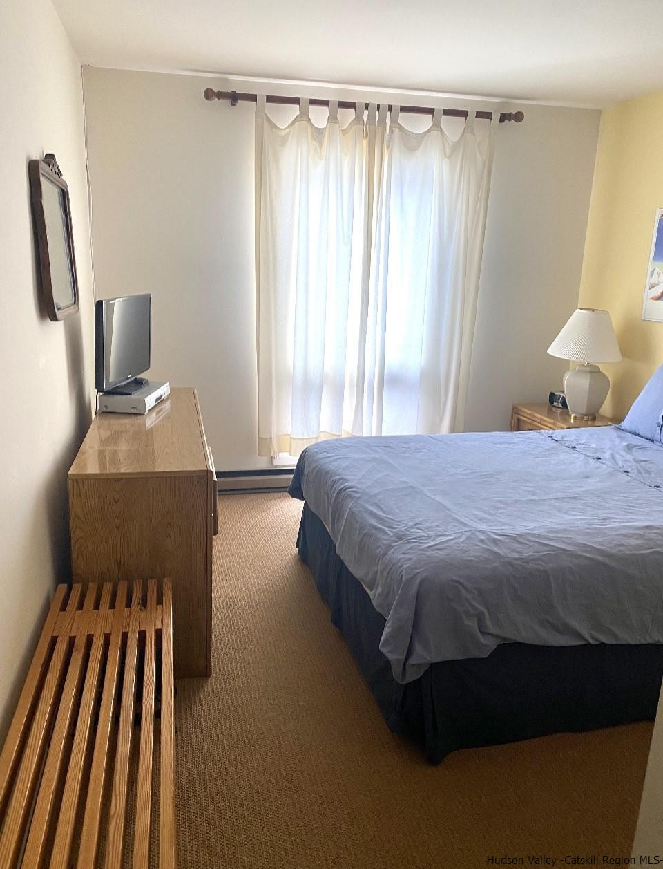 72 Hunter Ridge, Unit L1 Hunter, NY 12442 - Photo 17 of 23 a bedroom with a bed and wooden floor