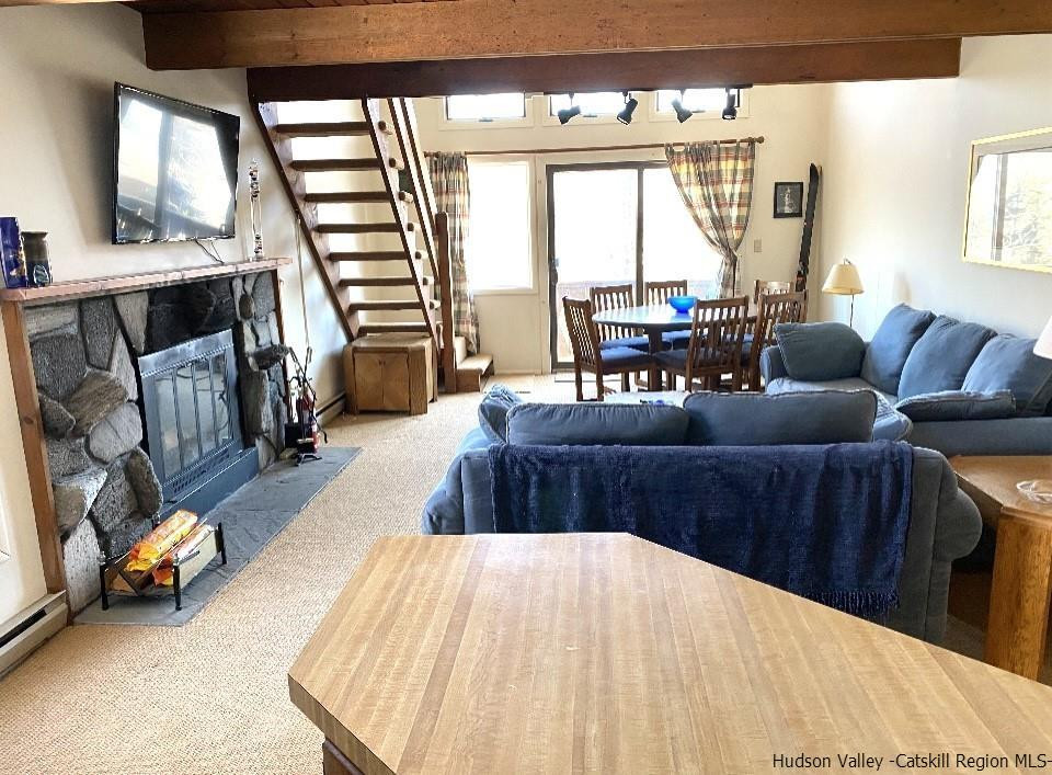 72 Hunter Ridge, Unit L1 Hunter, NY 12442 - Photo 2 of 23 a living room with furniture and a large window