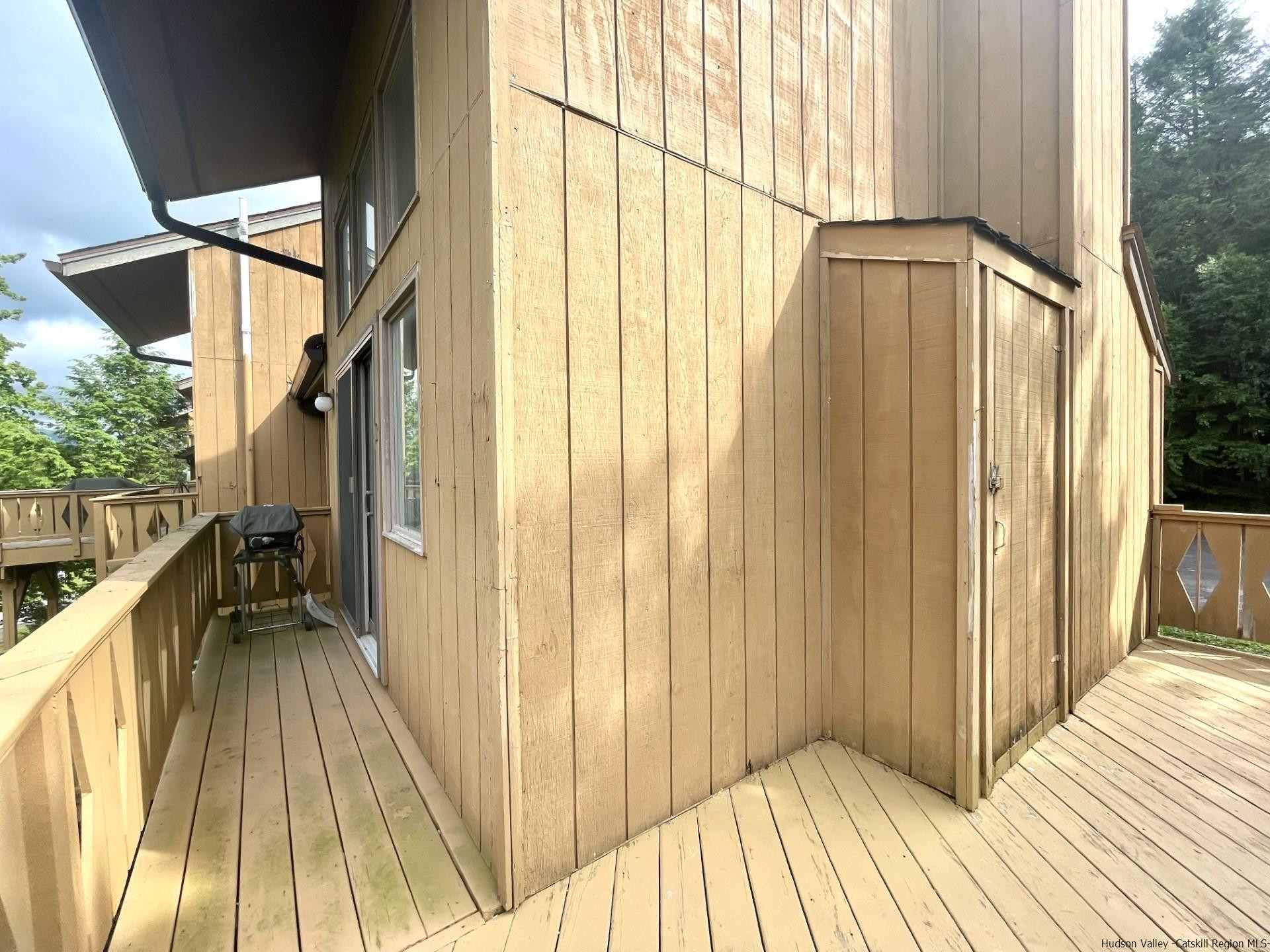 72 Hunter Ridge, Unit L1 Hunter, NY 12442 - Photo 21 of 23 a view of balcony with a glass door and wooden floor