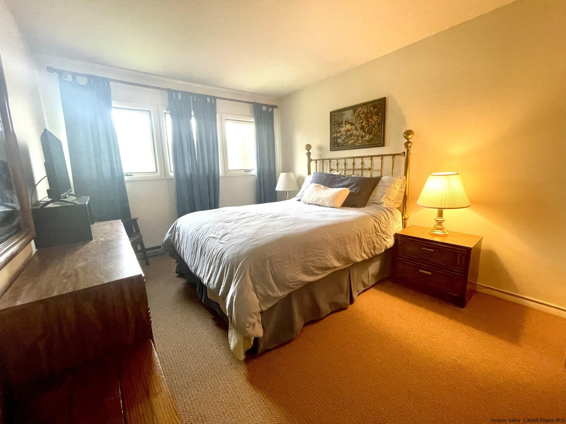 72 Hunter Ridge, Unit L1 Hunter, NY 12442 - Photo 7 of 23 a bedroom with a bed and a couch