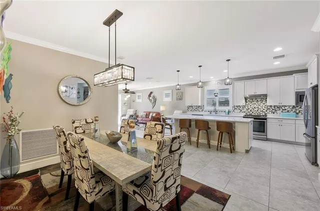 a view of a dining room with furniture and kitchen view