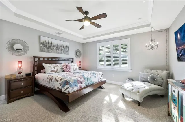 a bedroom with a bed and a ceiling fan