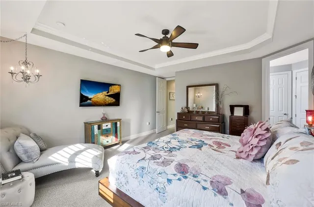 a bedroom with a bed and a chandelier