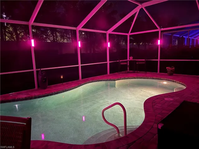 a room with pool table and glass windows