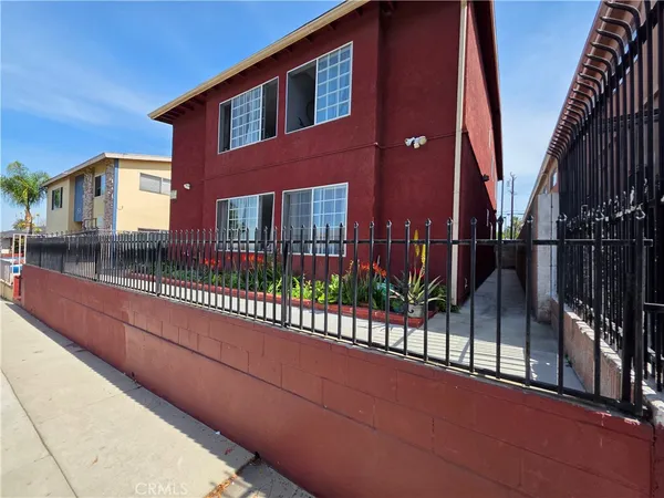a view of a house with iron fence