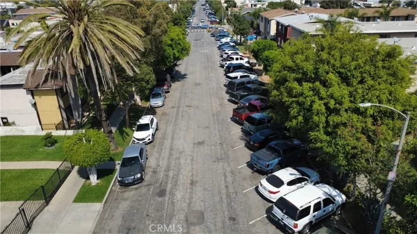 an aerial view of a house with garden space and street view