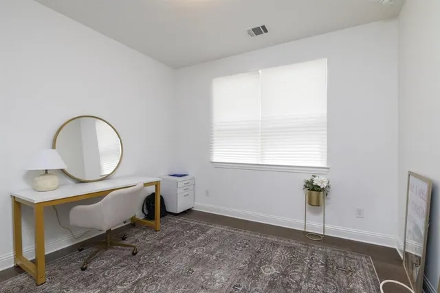 a room with furniture a window and mirror