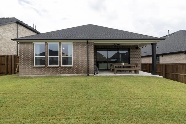 a view of a backyard with barn and wooden fence