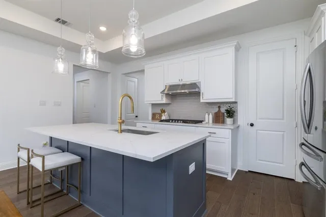 a kitchen with stainless steel appliances a sink stove and refrigerator
