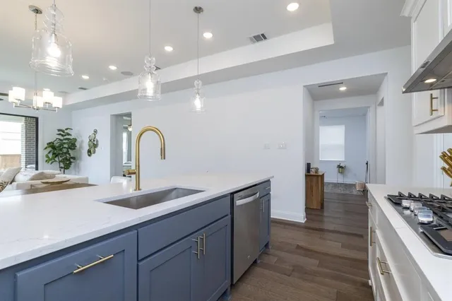 a kitchen with a sink and stove