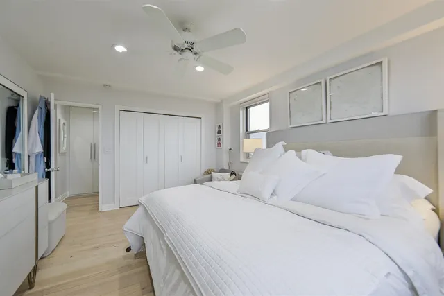 a spacious bedroom with a bed and a chandelier