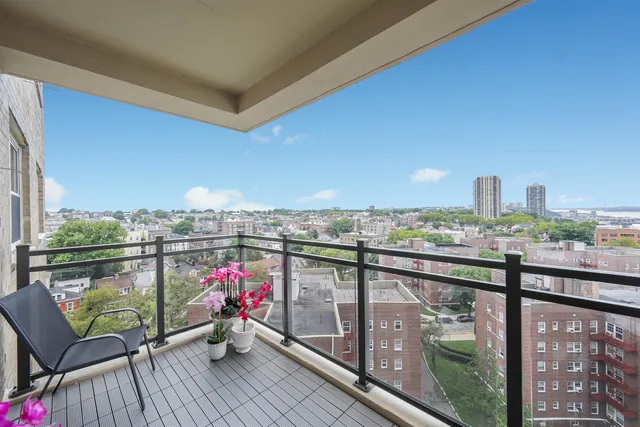 a view of a balcony with wooden benches