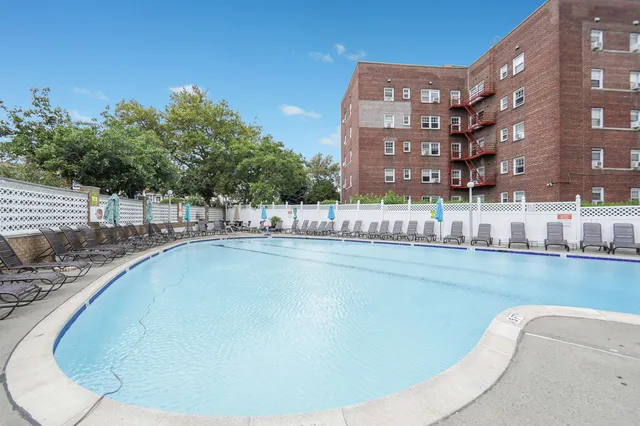 a view of a swimming pool with outdoor seating