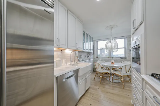 a kitchen with a sink cabinets and wooden floor