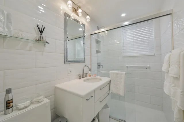 a bathroom with a sink mirror toilet and bathtub