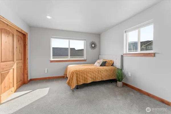 a bedroom with a bed and window