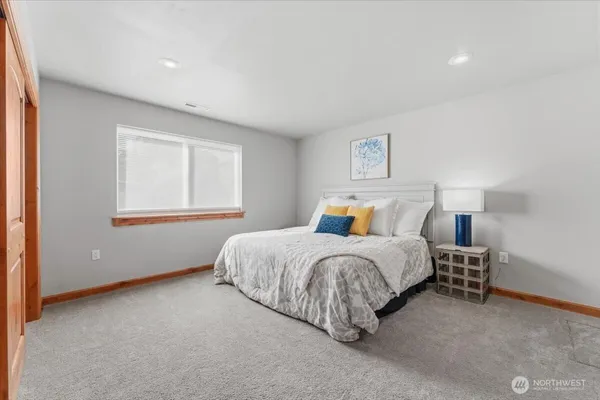 a spacious bedroom with a bed and a window