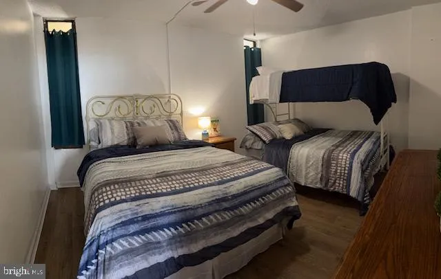 a bedroom with two beds and lamp