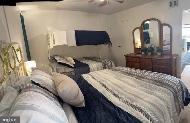 a bedroom with bed and a mirror