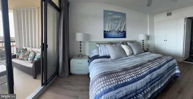 a bedroom with a bed and a painting on the wall