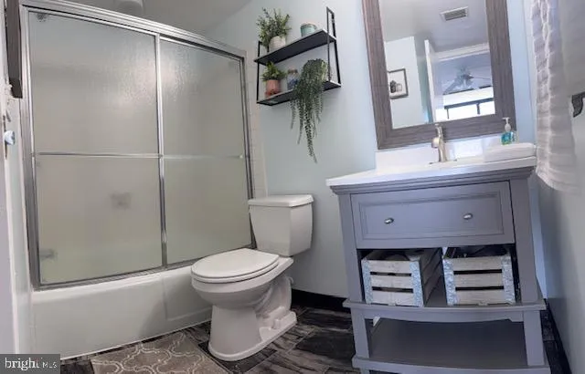 a bathroom with a toilet sink and shower