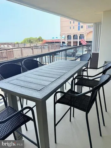 a view of a balcony dining area with furniture and wooden floor