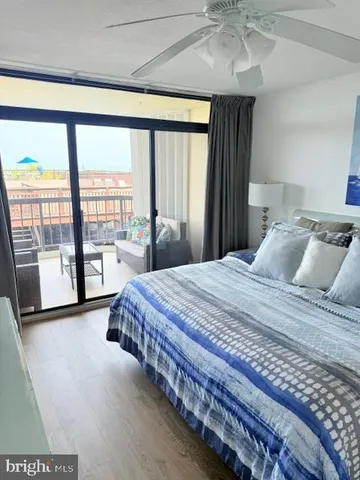 a bedroom with a large bed and a large window