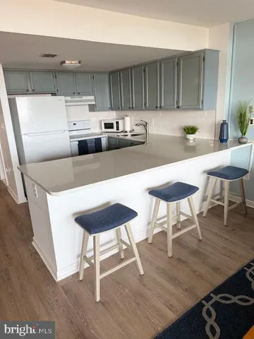 a kitchen with stainless steel appliances a dining table and chairs