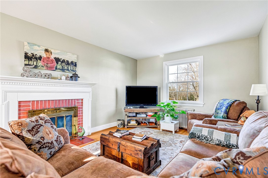 2172 Piping Tree Ferry Road Mechanicsville, VA 23111 - Photo 13 of 50 a living room with furniture a fireplace and a flat screen tv
