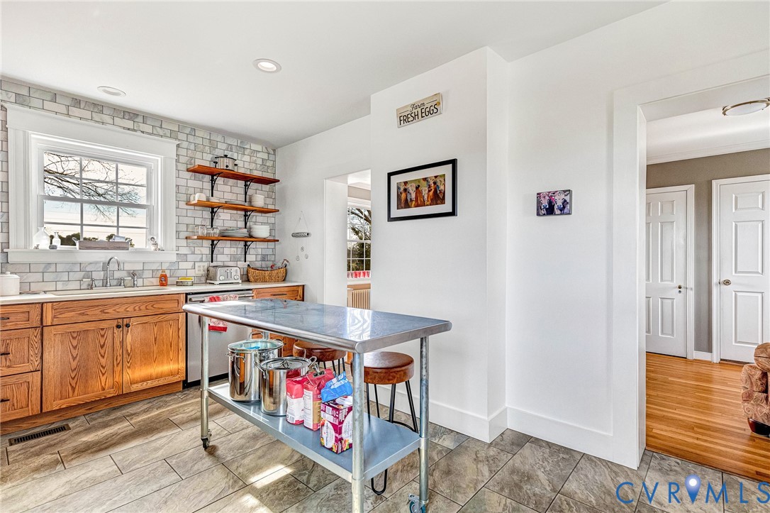 2172 Piping Tree Ferry Road Mechanicsville, VA 23111 - Photo 16 of 50 a kitchen with stainless steel appliances granite countertop a sink and cabinets