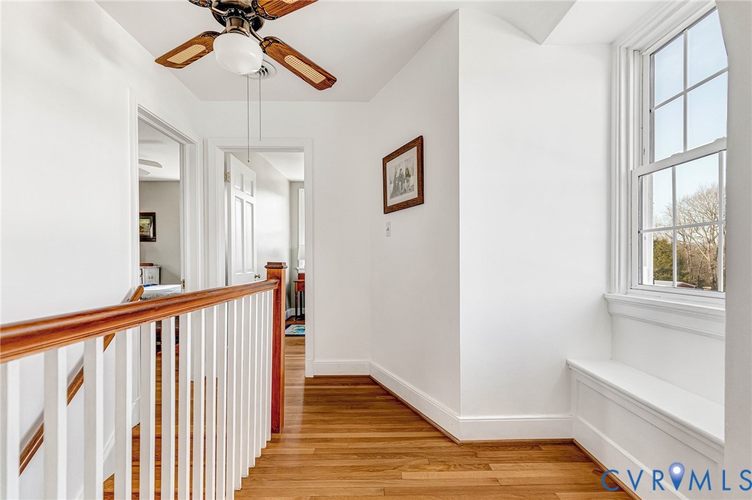 2172 Piping Tree Ferry Road Mechanicsville, VA 23111 - Photo 23 of 50 a view of a hallway with wooden floor and chandelier