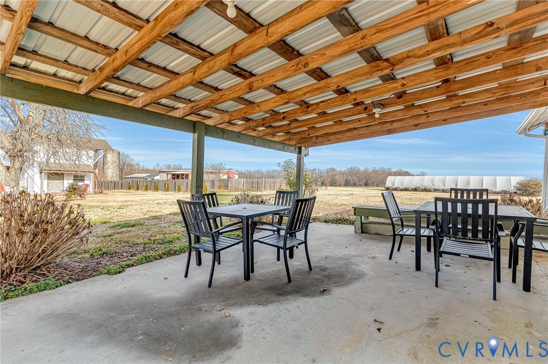 2172 Piping Tree Ferry Road Mechanicsville, VA 23111 - Photo 29 of 50 a dining room with furniture and a floor to ceiling window