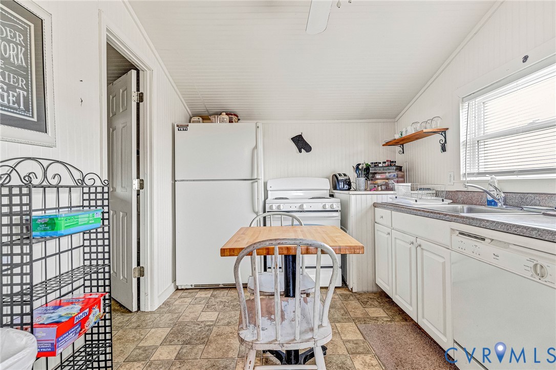 2172 Piping Tree Ferry Road Mechanicsville, VA 23111 - Photo 33 of 50 a kitchen with a sink a refrigerator and chandelier