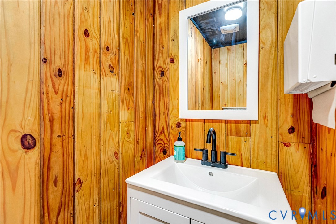 2172 Piping Tree Ferry Road Mechanicsville, VA 23111 - Photo 46 of 50 a bathroom with a sink a mirror and a shower