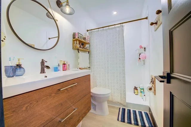 a bathroom with a sink a mirror and a toilet